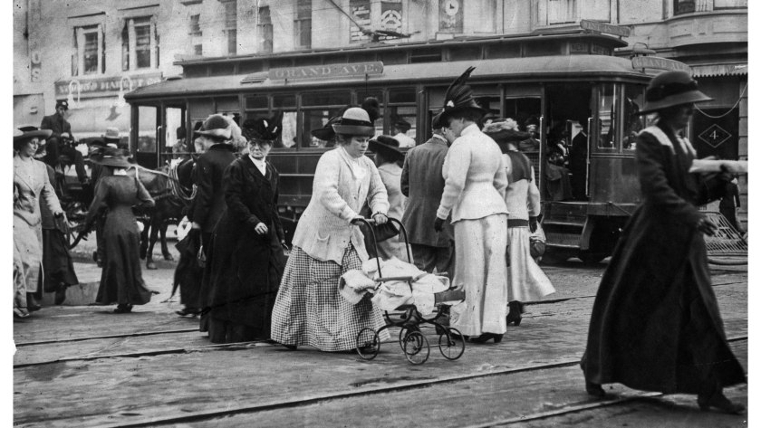Pedestrians in downtown Los Angeles in the early 1900s with Grand Ave. trolley car in background.