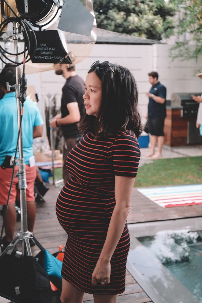 Elizabeth Ai on a film set, pregnant